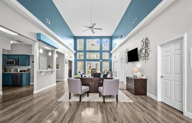 A modern kitchen with a dining area and a ceiling fan.