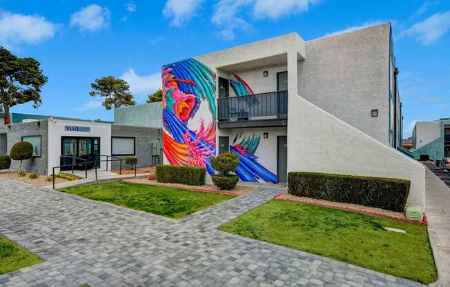 A modern building with a colorful mural on the side.