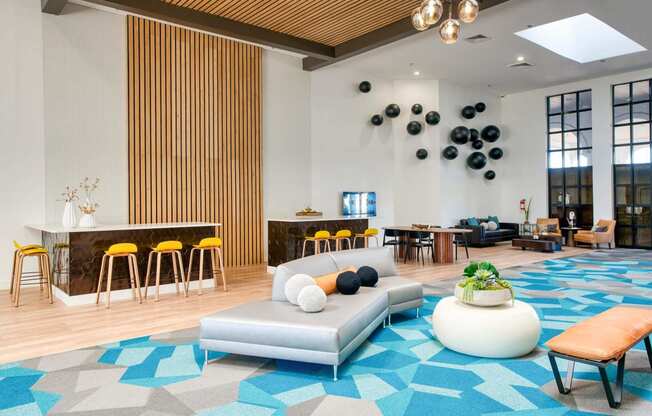 Lobby area with a couch and a bar at Presidio Palms Apartments, Tucson, AZ, 85701