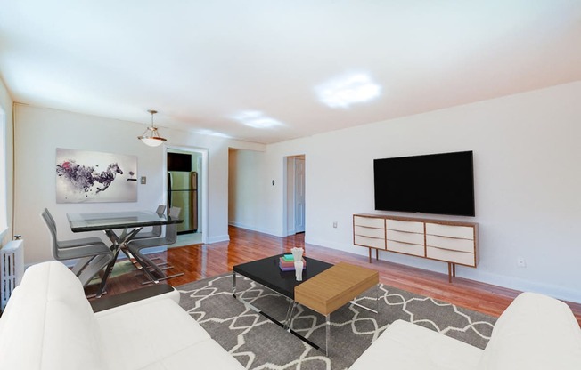 living area with credenza, tv, sofa, coffee table, hardwood floors and view of dining area  at hillside terrace apartments in washington dc