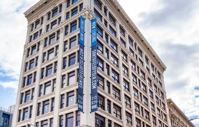 a tall building with a blue sign on the side of it