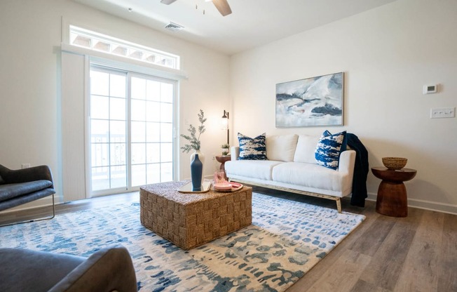 Living room with a white couch and a blue rug at Hadley Place Apartments, Pennsylvania, 17025