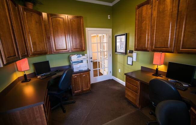 A room with green walls and wood cabinets.
