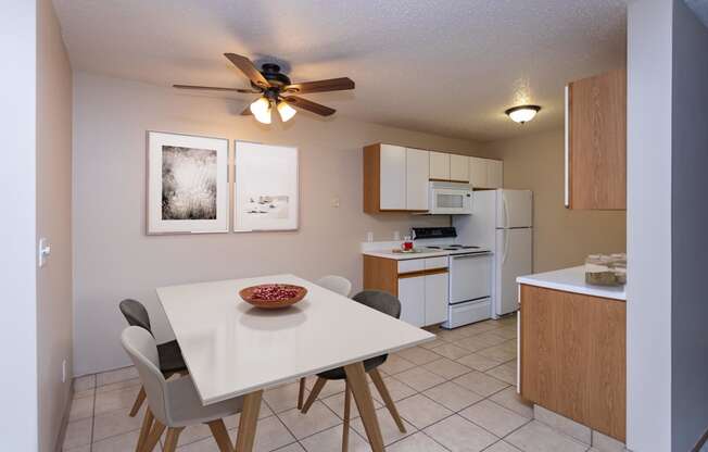 Kitchen with White Cabinets and Open Dining Room with Table