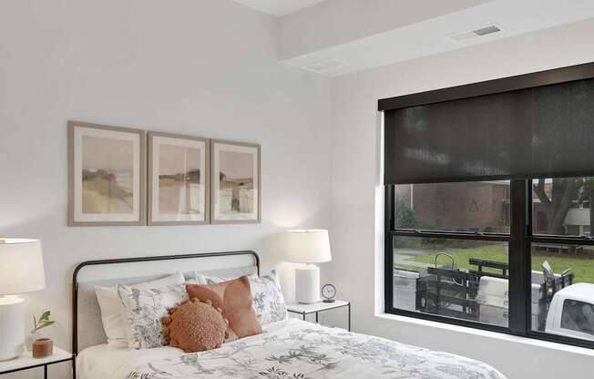 A bedroom with a large bed and a ceiling fan.