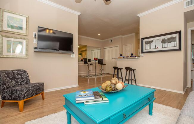 a living room with a teal coffee table