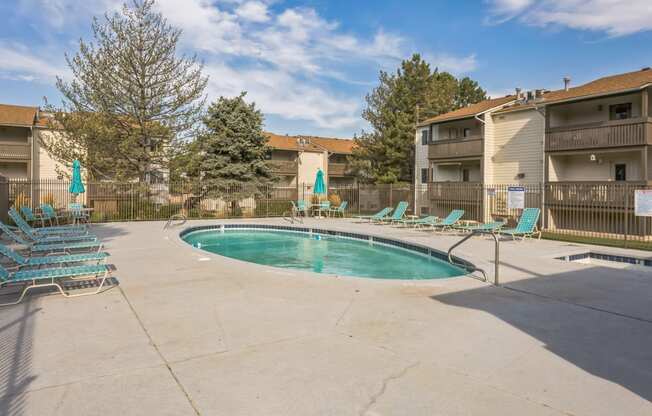 our apartments have a resort style pool with chairs and umbrellas