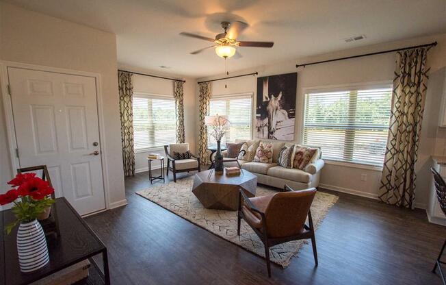 a living room with furniture and a ceiling fan