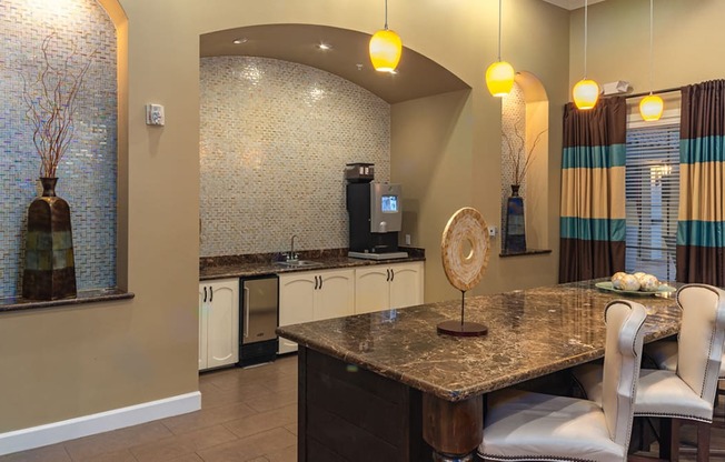 a kitchen with a table and chairs