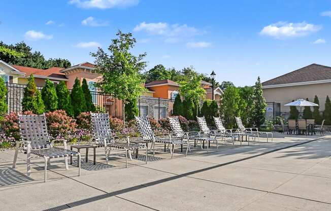 Row of chaise loungers by the pool at The Residences at Toscana Park in Granger, Indiana.