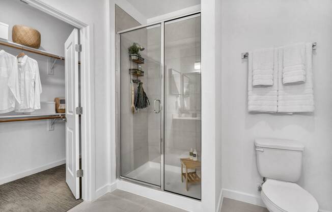 a white bathroom with a walk in shower