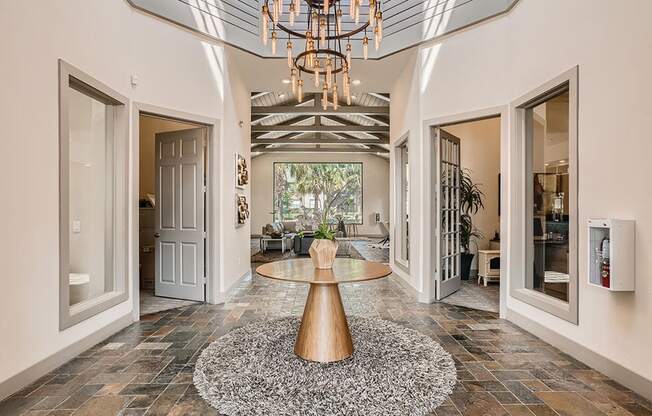 A modern interior with a large table and a chandelier.