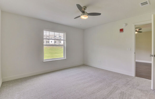 Master Bedroom with Ceiling Fan at Dodson Pointe Apartment Homes, Rogers, AR, 72758