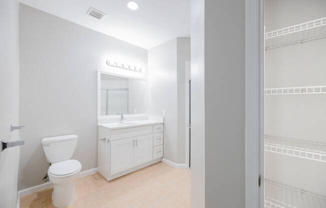 a white bathroom with a toilet and a sink