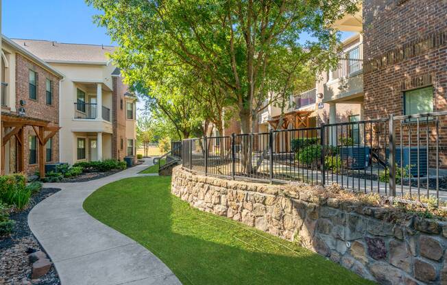 Community walking path with beautiful landscaping at Avenues at Craig Ranch apartments for rent