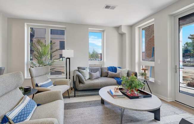 a living room with couches chairs and a coffee table