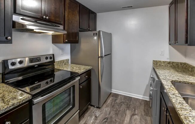 a kitchen with stainless steel appliances and granite counter tops