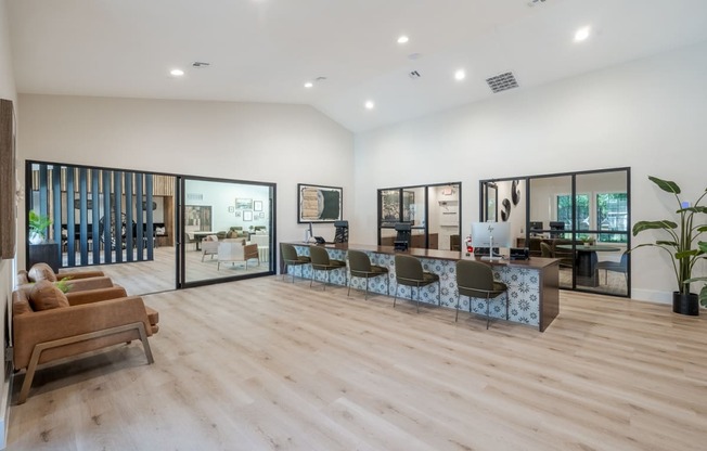 a living room with a table and chairs in the middle of it
