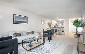 a living room with a couch and a coffee table and a dining room and kitchen  at Brix, Walla Walla, WA, 99362