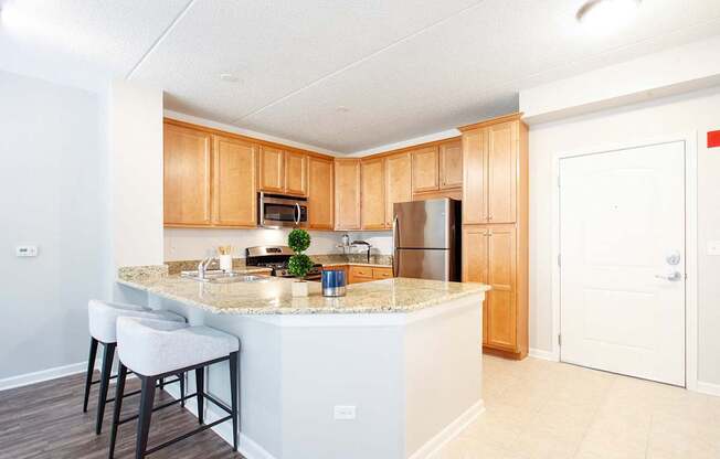 A kitchen with a white island and wooden cabinets.