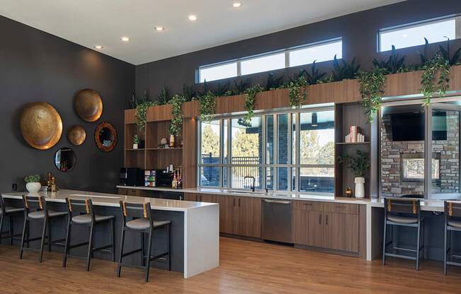A bar area with a long counter and chairs.