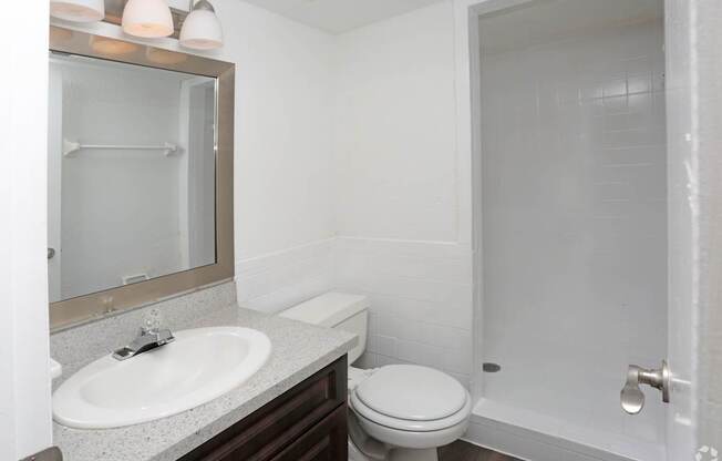 A white toilet sits next to a sink in a bathroom.