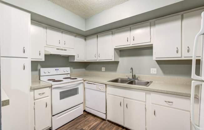 The Commons Apartments in Tampa Florida photo of a kitchen with white cabinets and white appliances