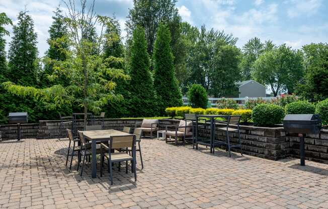 a patio with tables and chairs on a brick patio