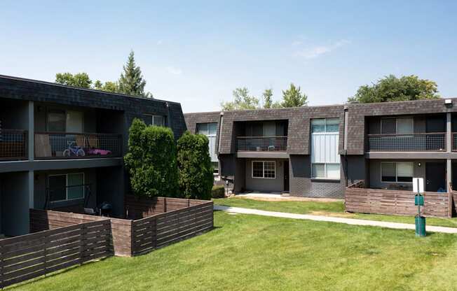 Apartment buildings with green lawns in front.
