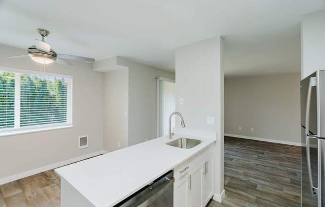 A kitchen with a white countertop and a refrigerator.