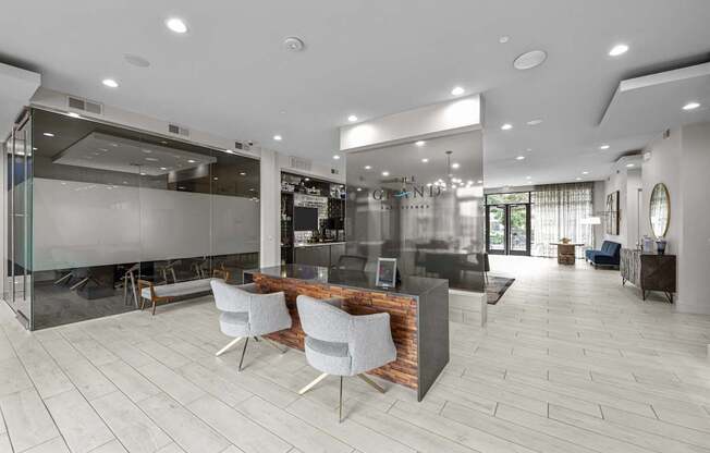 a large lobby with a reception desk and chairs