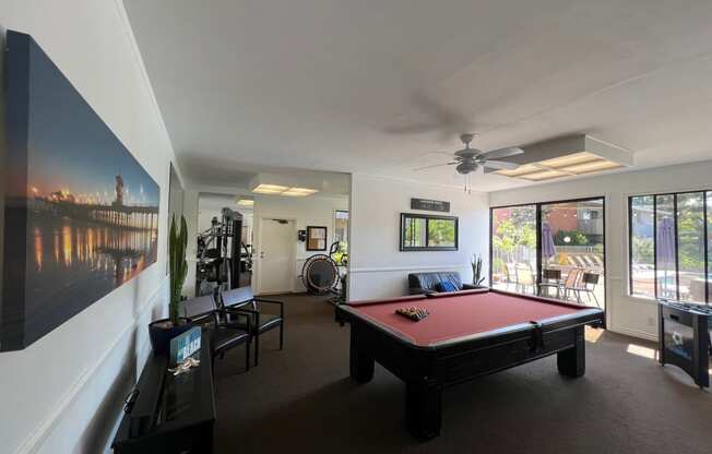 a pool table in a living room with a view of a river