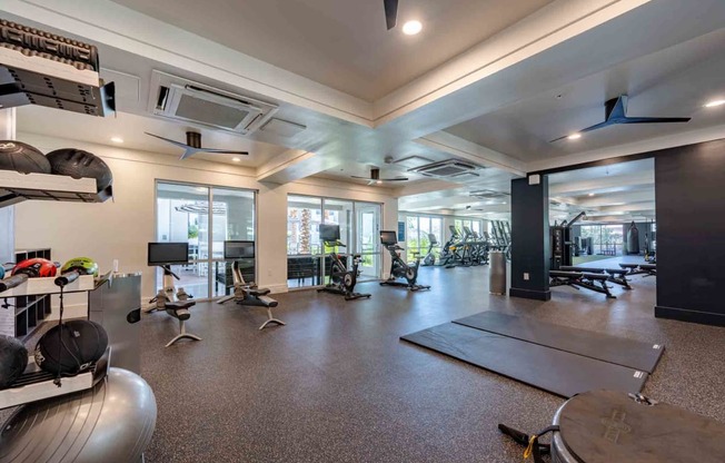 a spacious fitness center with cardio equipment and weights at slate scottsdale apartments in arizona