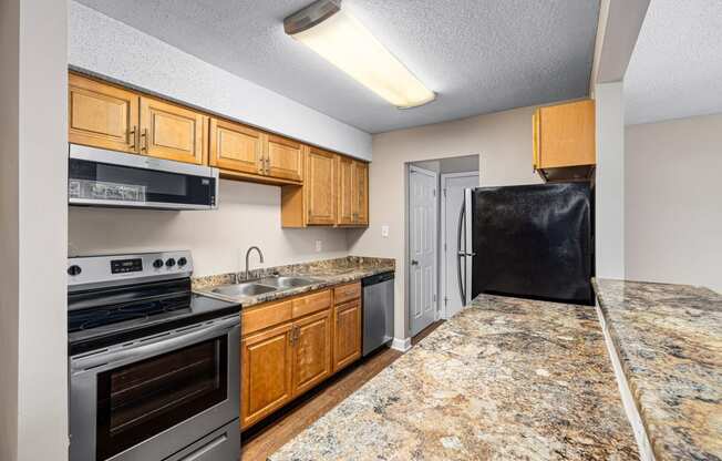 a kitchen with wooden cabinets and granite countertops