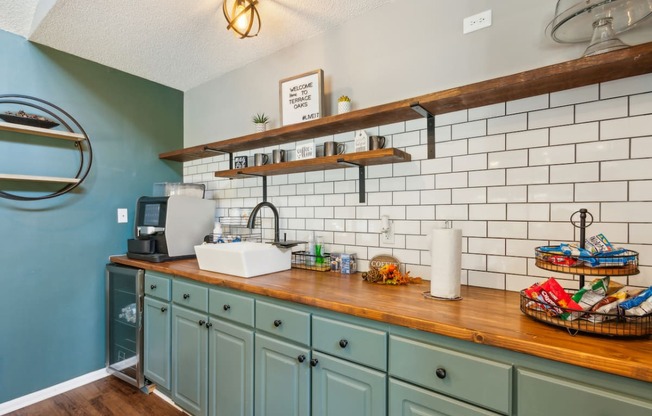 a kitchen with blue cabinets and a counter top and a sink