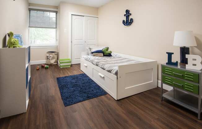 a bedroom with a bed and a dresser and a window