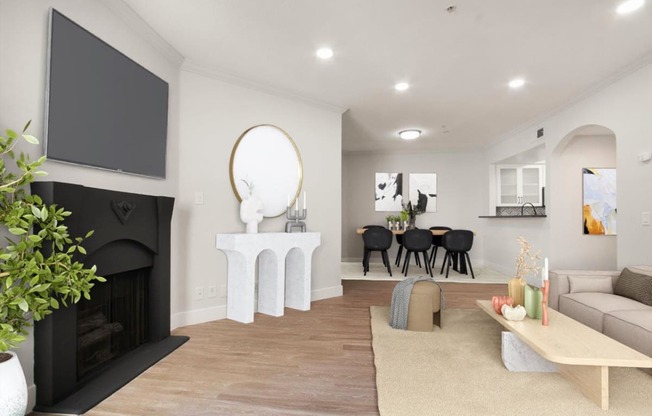 a living room with a fireplace and a tv at Burton, Los Angeles