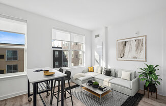 Model Living Room with Wood-Style Flooring and Window View at Stella Apartments located in New Carrollton, MD.