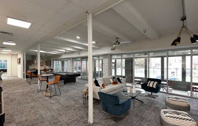 A spacious room with a long table and chairs.