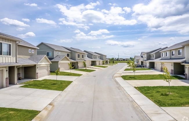 Well-maintained landscaping with manicured shrubs and paved walkways.