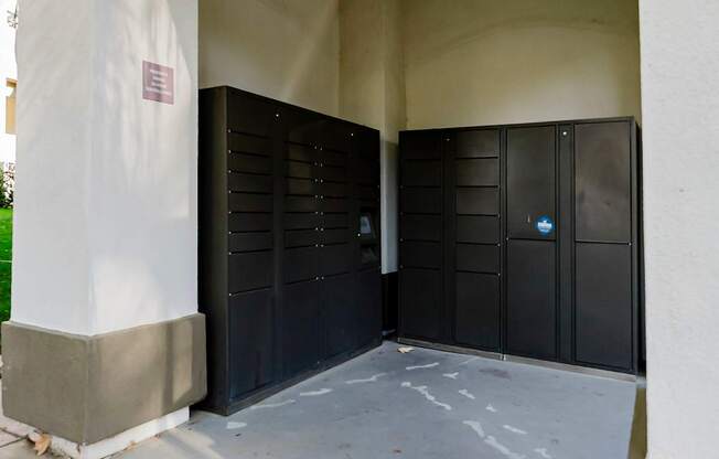 A black metal gate with a blue sign on it.