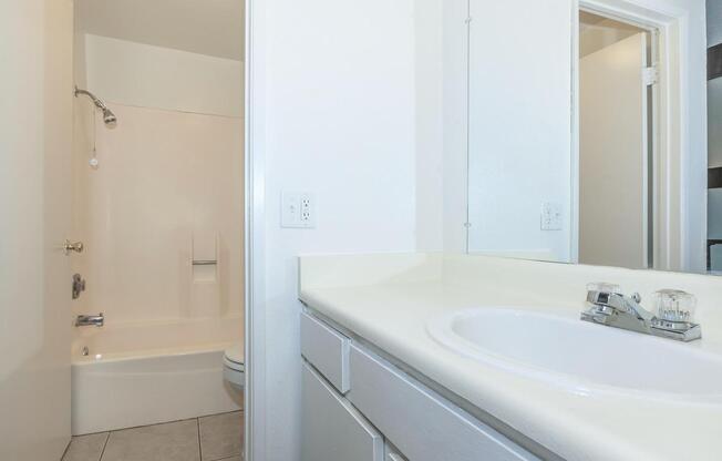 a large white tub sitting next to a sink