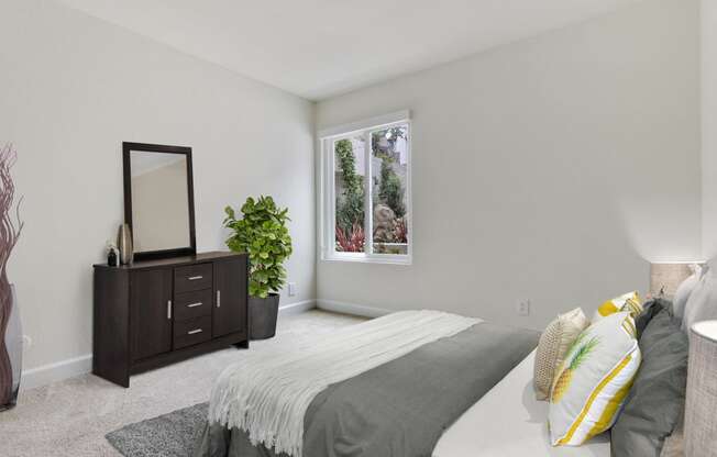 Bedroom with carpet flooring, sliding window on the right. Not all features are available in every apartment.