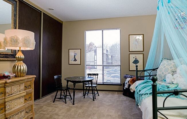 a bedroom with a bed and a dresser and a window