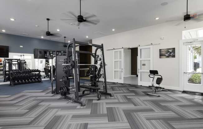 a home gym with exercise equipment and a chevron tile floor