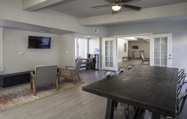 a living room with a large wooden table and chairs