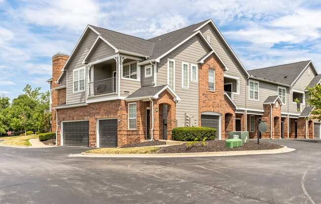 a large house with a driveway and a street in front of it