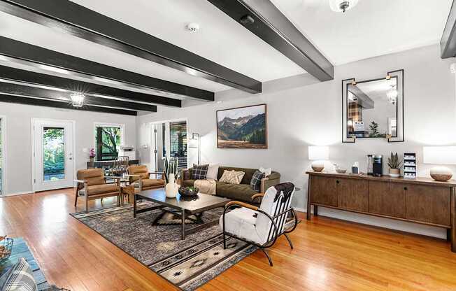 A sitting room with a black and white striped ceiling and a large painting on the wall.