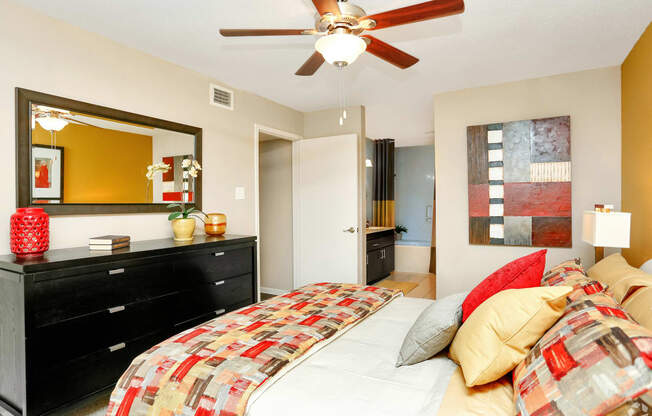 a bedroom with a bed and a ceiling fan