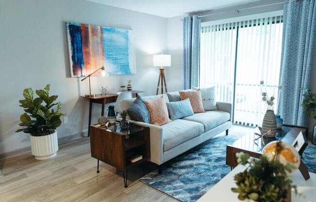 a living room with a couch and a table and a window